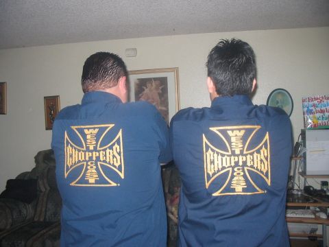 1986 Ford Bronco - Two men are shown from behind, each wearing a blue shirt with the West Coast Choppers logo on the back.