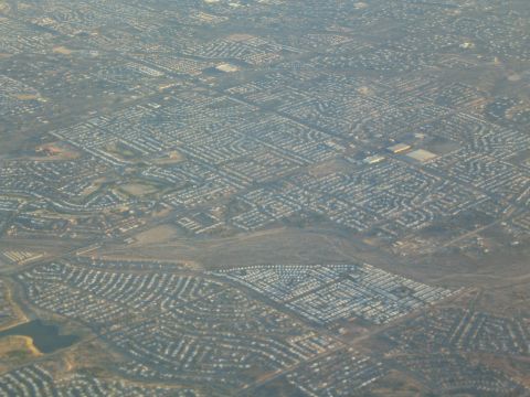 1968 Ford Mustang - An aerial perspective captures a vast expanse of residential homes, illustrating the organized layout of a modern suburb.