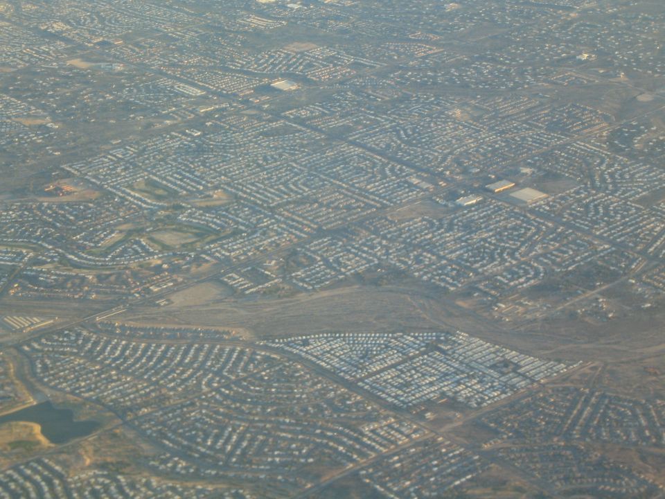 Aerial view of a suburban neighborhood with dense housing and winding streets