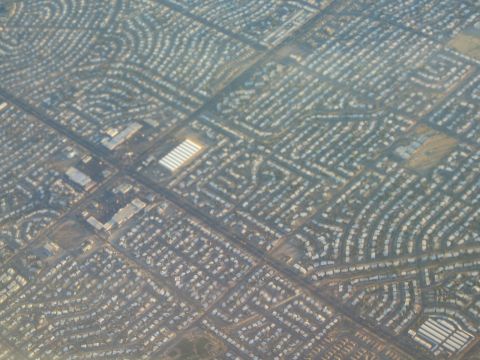 1968 Ford Mustang - An aerial perspective captures the intricate pattern of a suburban housing development with its winding roads and uniform homes.