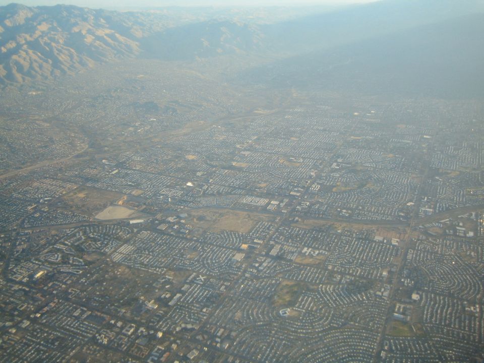 Aerial view of a dense urban area with mountains in the distance