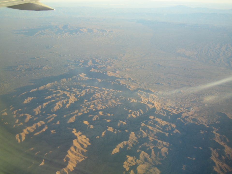 Aerial view of desert mountains from an airplane window