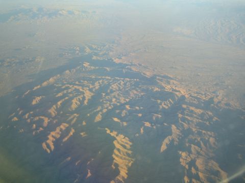 1968 Ford Mustang - An aerial perspective captures the vastness of a desert mountain range bathed in soft, diffused light.
