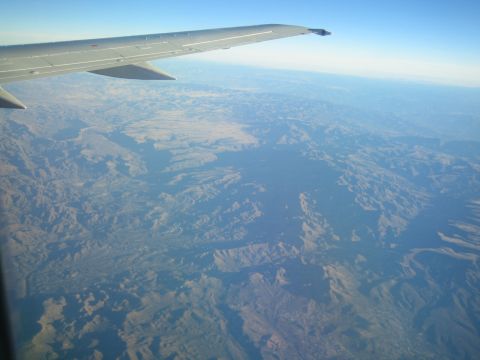 1968 Ford Mustang - View from an airplane window shows the wing and the , undeveloped landscape below.