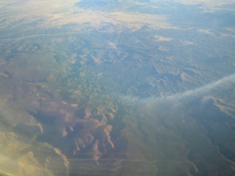 1968 Ford Mustang - View from airplane window shows vast, undeveloped mountainous terrain below.