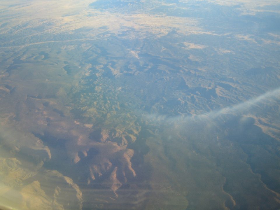 Aerial view of arid, mountainous landscape with some haze