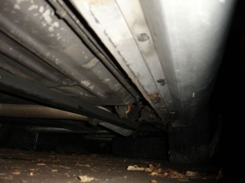 1992 Ford Taurus - Underside view of a vehicle, focusing on the subframe connectors and exhaust system.