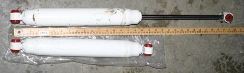 2003 Jeep TJ - A ruler measures the length of two white shock absorbers, one of which is still in its plastic packaging.