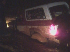 1986 Ford Bronco - This vehicle appears to be stuck in mud, with its rear lights illuminated in the dark.