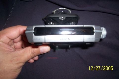 1995 Ford Bronco - A Sirius satellite radio receiver is held in a hand, with a date stamp of 12/27/2005 visible.