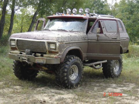 1978 Ford Bronco - This heavily modified Ford Bronco is covered in mud, suggesting it has been used for off-roading.