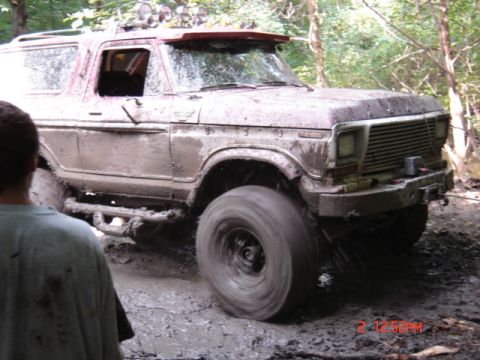 1978 Ford Bronco - This 1978 Ford Bronco navigates a muddy trail, its off-road modifications evident.