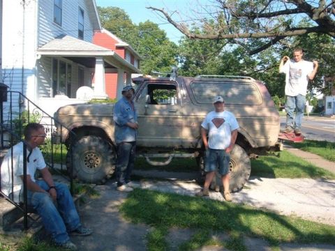 1978 Ford Bronco - A group of people pose with a lifted Ford Bronco on a sunny day.