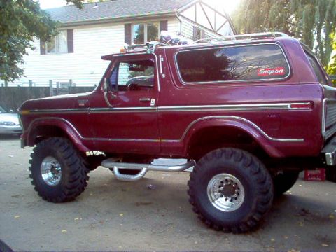 1978 Ford Bronco - Maroon 1978 Ford Bronco lifted with large off-road tires, a Snap-on sticker on the window.