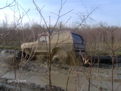1978 Ford Bronco - This 1978 Ford Bronco navigates a challenging muddy terrain, kicking up dirt as it goes.