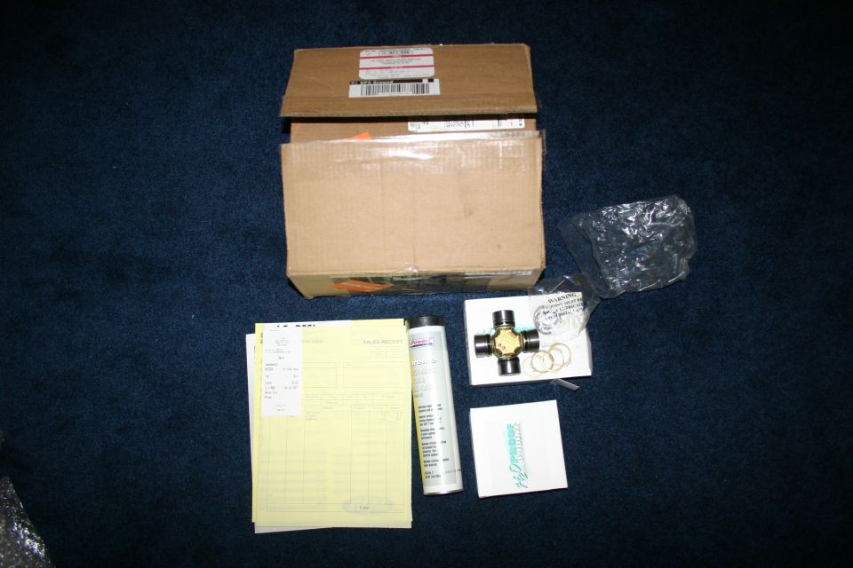 Universal joint with paperwork and boxes on a blue carpet