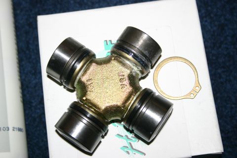 2003 Jeep TJ - A universal joint part with 'USA' stamped on it is shown with a snap ring.