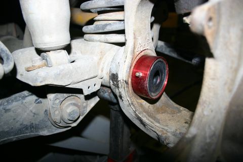 2003 Jeep TJ - Aftermarket suspension bushing installed on a Jeep TJ axle, likely for upgraded performance.