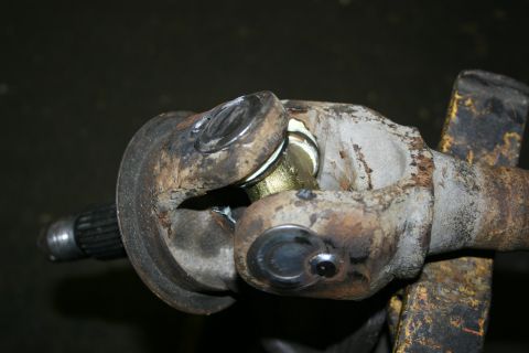 2003 Jeep TJ - Close-up of a universal joint assembly, highlighting its mechanical components and signs of use.
