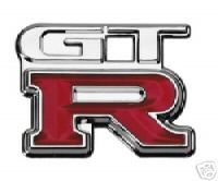 1970 Ford Ranchero - Close-up of a red and chrome GT-R emblem, likely a car badge.
