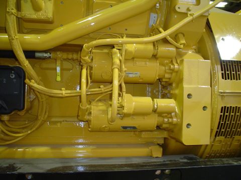 1966 International School Bus - Yellow engine components, possibly from a generator or heavy equipment, with 'CATERPILLAR' branding.