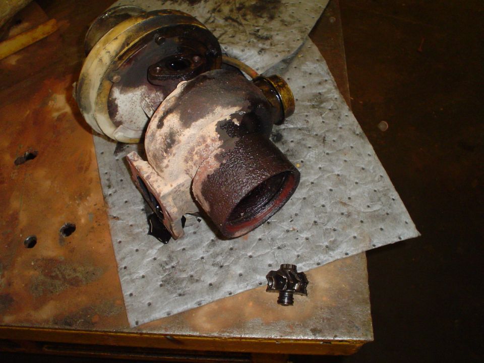 turbocharger and wastegate actuator disassembled on a workbench