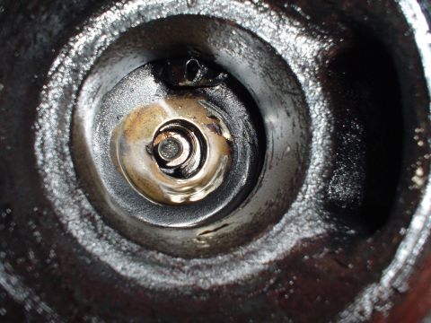 1966 International School Bus - This is a close-up view of an engine's cylinder head, showing internal components and oil buildup.