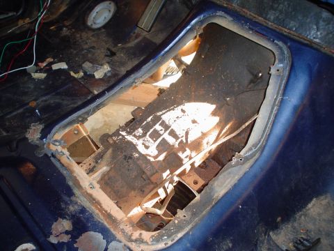 1984 Ford Bronco - Interior view of a vehicle's floor pan with the transmission tunnel opening exposed.