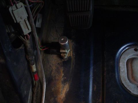 1984 Ford Bronco - Close-up view of wiring and a component on a vehicle's dashboard.