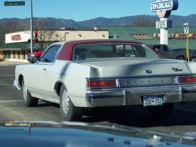 1972 Ford Ranchero - This large sedan features a two-tone paint scheme with a white body and red roof.