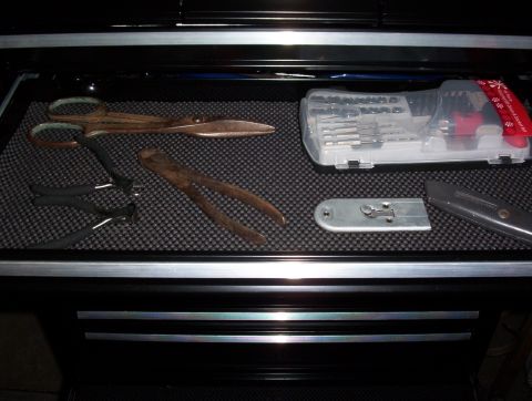1993 Ford Bronco - A toolbox drawer contains various hand tools including scissors, pliers, wire cutters, a utility knife, and a drill bit set.
