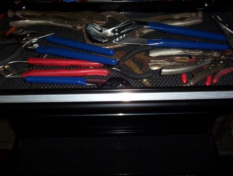 1993 Ford Bronco - A collection of various hand tools, including pliers and wrenches, are organized within a toolbox.