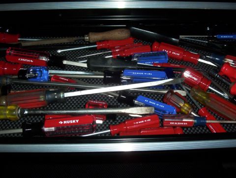 1993 Ford Bronco - A collection of screwdrivers fills a toolbox drawer, showing a variety of brands and handle colors.
