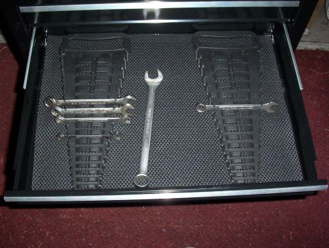 1993 Ford Bronco - A toolbox drawer contains wrenches organized on black holders, with a single wrench in the center.