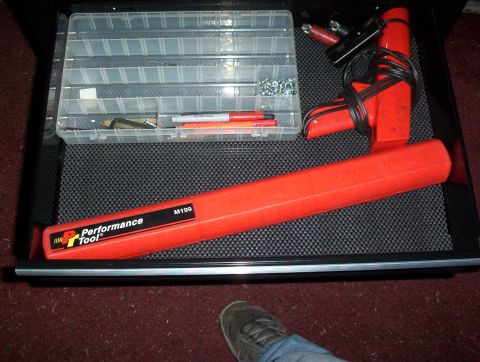 1993 Ford Bronco - Contents of a toolbox drawer, including a torque wrench and assorted hardware.