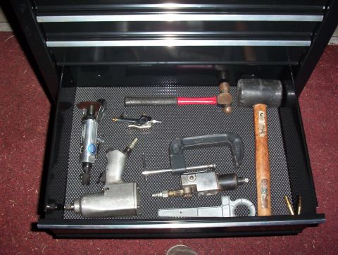 1993 Ford Bronco - A variety of automotive tools are neatly organized inside a black toolbox drawer.