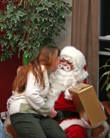 1991 Ford Bronco - A woman gives Santa Claus a kiss while he holds a wrapped gift.