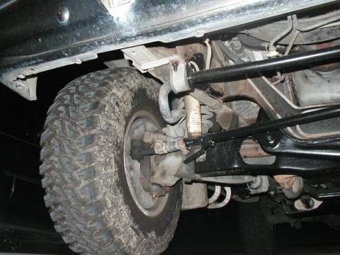 1989 Ford Bronco - Undercarriage view of a 1989 Ford Bronco, showing the front suspension and undercoating.