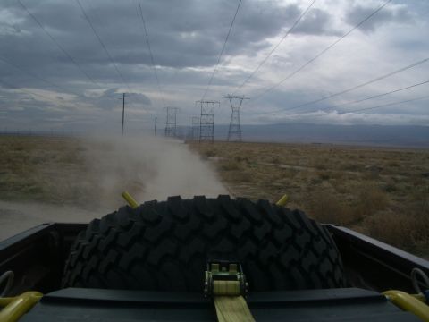 1985 Ford Ranger - Driving down a dusty road with power lines stretching into the distance, seen from the perspective of the truck bed.