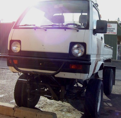 1995 Ford Bronco - This modified mini truck has a significantly lifted suspension and oversized tires, giving it a unique stance.