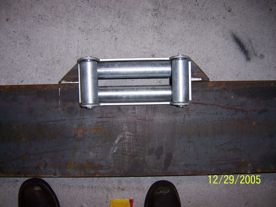 Welded steel roller fairlead mounted to flat steel plate on garage floor, dated 12/29/2005