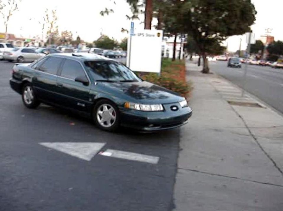 dark green 1993 Ford Taurus parked on street, front quarter view