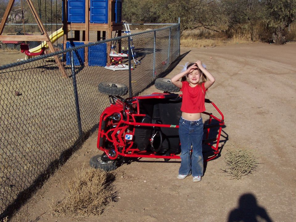 Red go-kart overturned on its side