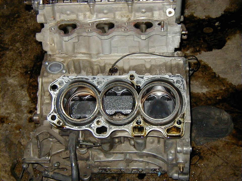 Missing chuck of piston and ring poking up through the hole.