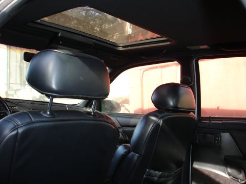 1992 Ford Taurus - Interior view of a 1992 Ford Taurus, showing black leather seats and a sunroof.