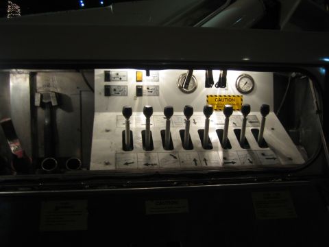 1968 Ford Mustang - A control panel with multiple levers and gauges is visible inside a vehicle.