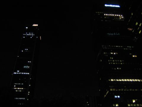1968 Ford Mustang - Night view of illuminated skyscrapers in a city, showing architectural details and lights.