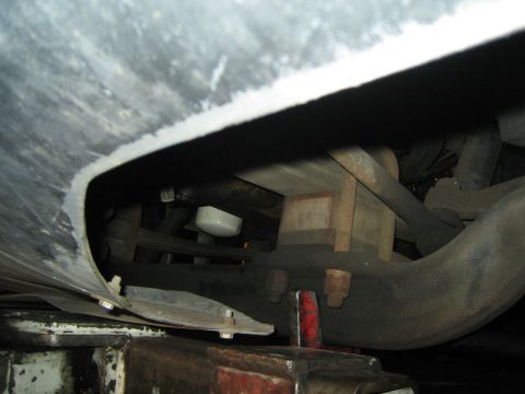 1968 Ford Mustang - A close-up shot of the undercarriage reveals mechanical parts and a white oil filter.