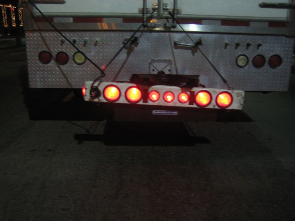 Trailer tail light bar with multiple red lights illuminated