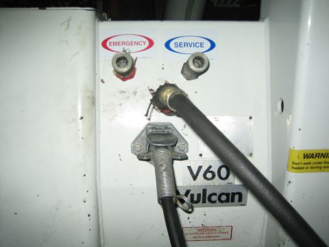 1968 Ford Mustang - A close-up view of a Vulcan V60 service panel with hoses attached, emergency, and service labels.